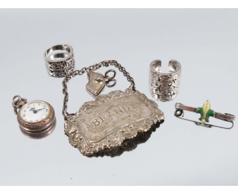 A hallmarked silver bottle ticket, engraved Brandy, together with a hallmarked silver pendant formed as a dogs head, various 