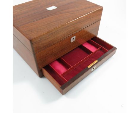 A 19th century rosewood ladies jewellery box, with mother of pearl escutcheons, the interior fitted with a mirror to the lid,