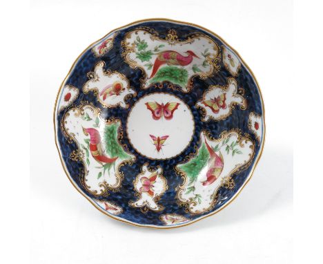 An 18th Century Worcester chocolate&nbsp; saucer, decorated with reserves of fabulous birds and insects, mock Worcester seal 
