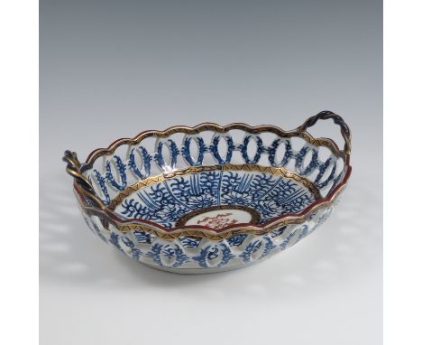 A 19th century unmarked Worcester pierced oval basket, decorated in the Royal Lily pattern, with twist handles, maximum diame