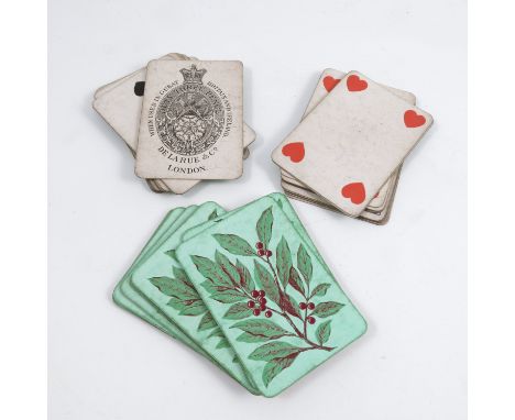 An Antique pack of De La Rue &amp; Co London playing cards, fifty-two cards decorated to the reverse with leaves and berries 