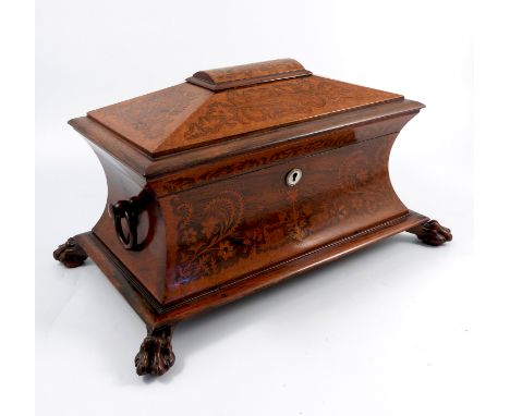 A 19th century mahogany sarcophagus shaped tea caddy, with waisted sides, having marquetry panels to the front and lid, raise