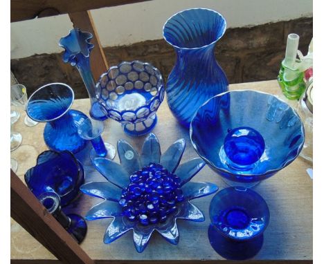 A selection of blue glass wares to include two Dartington vases with wrythen moulded finish, one of baluster form, the other 