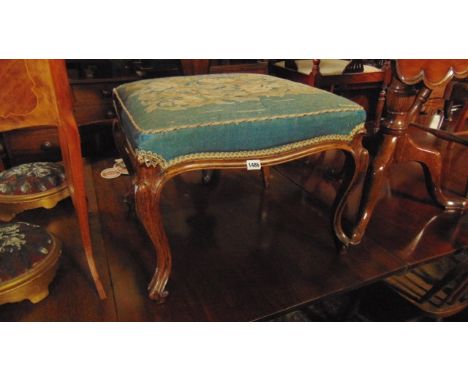A mid 19th century centre stool in walnut of square cut form and raised on cabriole supports with handworked floral tapestry 