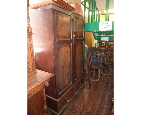A Georgian mahogany robe enclosed by two panelled doors partially fitted with two frieze drawers on bracket supports
