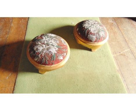 A pair of Victorian footstools of circular form with hand worked tapestry and beadwork detail and later painted frames 