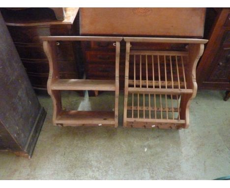 A small stripped pine wall mounted plate drying rack with shaped outline and an inset old penny, together with a matching fli