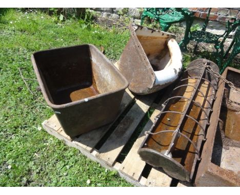 A vintage cast iron wall mounted and bow fronted corner feeding trough with partially painted finish together with one other 