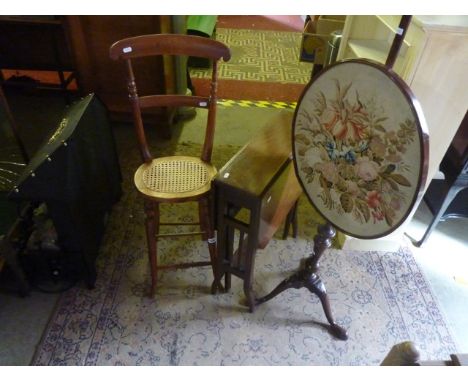 A Georgian mahogany pole screen with an oval framed floral tapestry panel, raised on a partially turned column and swept trip