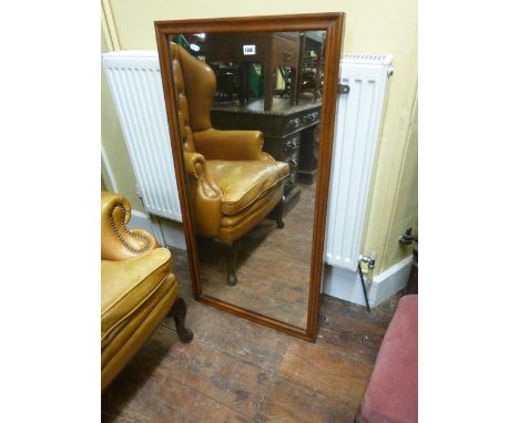 A Victorian wall mirror of rectangular form within a cushion moulded mahogany frame, 110 cm x 57