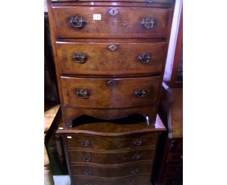 A small Georgian style walnut veneered bedroom chest of three long graduated drawers beneath a brushing slide over a shaped a