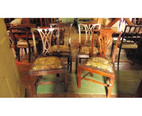A harlequin  set of four Georgian mahogany and fruitwood dining chairs with shaped and pierced splats and shaped cresting rai