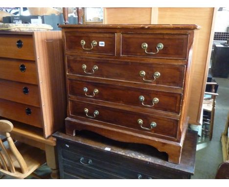 A small reproduction yew wood veneered bedroom chest in the Georgian style fitted with three long and two short drawers, rais