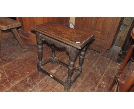 An antique oak coffin/joint stool of rectangular form in turned supports