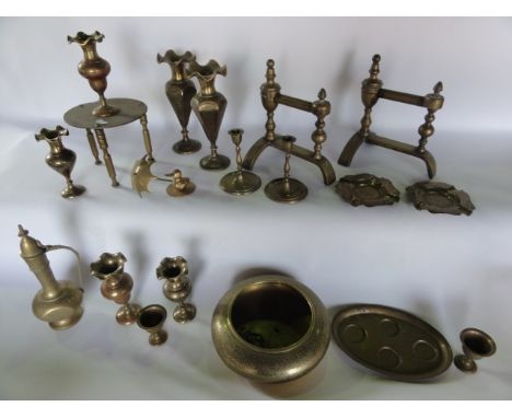 A selection of brassware to include a pair of fire dogs with urn shaped stems, a quantity of eastern enamelled brassware to i