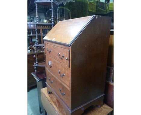 A small inlaid Edwardian mahogany ladies writing bureau with stainwood banding, the fall front enclosing a simply fitted inte