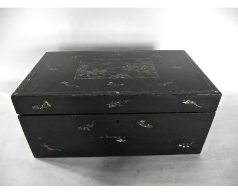 A good quality vintage black lacquered writing slope with extensive inlaid mother of pearl detail, the lid decorated with an 