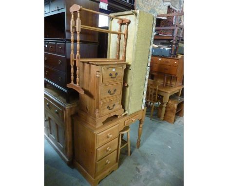 A modern stripped pine kneehole single pedestal dressing table fitted with an arrangement of four drawers, a further stripped