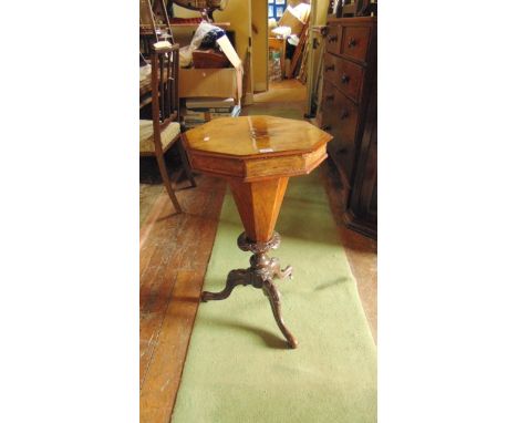 A Victorian walnut and figured walnut trumpet shaped work box of usual form raised on a turned column and carved tripod base