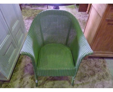 A vintage Lloyd Loom tub chair with swept arms and original green colourway