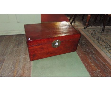 A Chinese trunk with red lacquered finish with brass fittings, lined interior containing a number of old scrolls