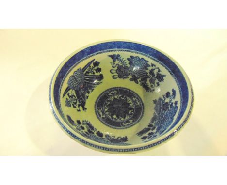 A 19th century Chinese basin of circular form with blue and white painted decoration of flowers to the interior, trophies, et