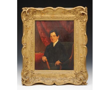 A 19th century oil painting on canvas, half length portrait of a seated gentleman in black jacket and white cravat holding a 