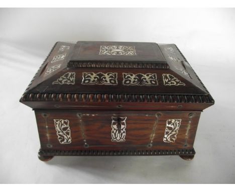 A good quality 19th century rosewood veneered sarcophagus shaped jewellery box with extensive mother-of-pearl inlay, the hing