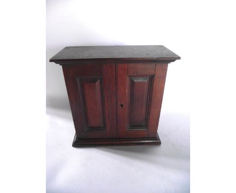 A good quality small wall hanging mahogany key cabinet, the twin hinged panelled doors revealing an interior housing 20 brass