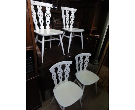 A set of four Ercol dining chairs with triple pierced fleur-de-lys style slatted backs, with later all over painted finish