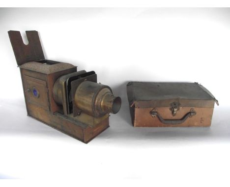 A Victorian antique magic lantern assembly, the metalwork case accommodating  a large lens, 34 cm long approx together with s