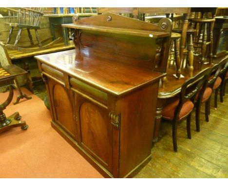 An early Victorian mahogany chiffonier, the lower section enclosed by two arched and panelled doors over two cushion moulded 