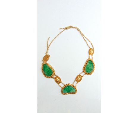 A Chinese jadeite and gilt metal necklace, composed of three shaped carved jadeite plaques mounted with grape and mouse detai