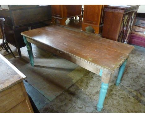 A vintage kitchen table of rectangular form, partially painted and stripped and raised on four turned tapered legs, to seat 6