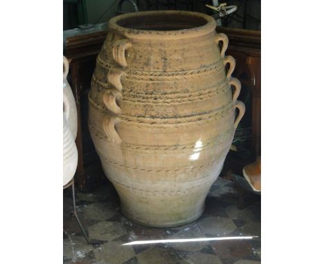 A contemporary terracotta olive jar/planter, oviform with banded, simply incised detail and small applied loop handles 84 cm 