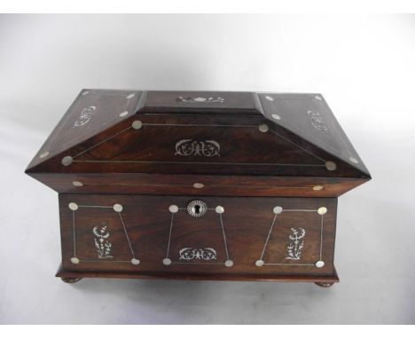 A good quality 19th century rosewood veneered sarcophagus shaped tea caddy, the exterior with extensive mother-of-pearl inlai