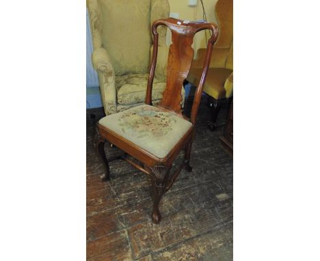 An 18th century walnut side chair with vase shaped splat, yoke shaped  cresting rail and raised on shaped forelegs with shell