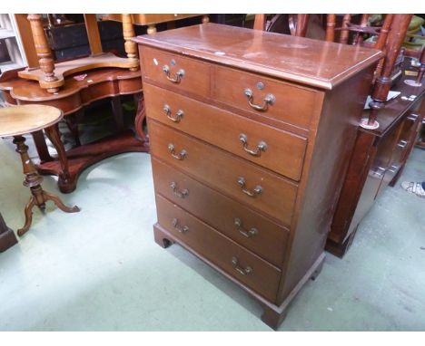 A Georgian style mahogany bedroom chest of four long and two short drawers with brass swan neck handles and bracket supports