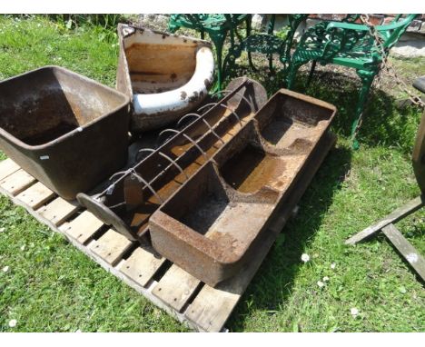 A vintage cast iron pig feeding trough with six hooped divisions together with one other 