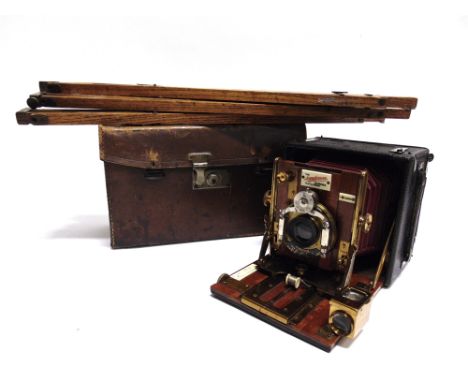 A SANDERSON MAHOGANY & LACQUERED BRASS FOLDING BELLOWS CAMERA  with a black leather body, in a leather travel case; together 