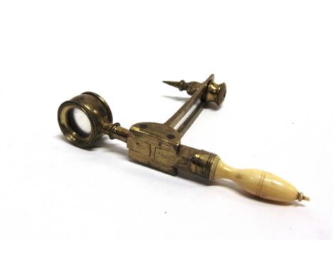 A 19TH CENTURY BRASS BOTANIC COMPASS  with a turned ivory handle, 72mm high, 51mm long. 