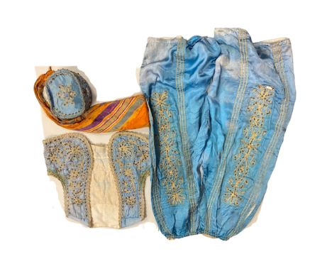 A Middle Eastern embroidered blue silk waistcoat, matching trousers and hat, waistcoat size 44 x 49cm, trouser length approx 