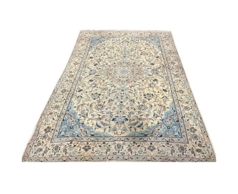 A Central Persian carpet, circa mid 20th century, the ivory field with a large central medallion, scrolling flowering leafy v
