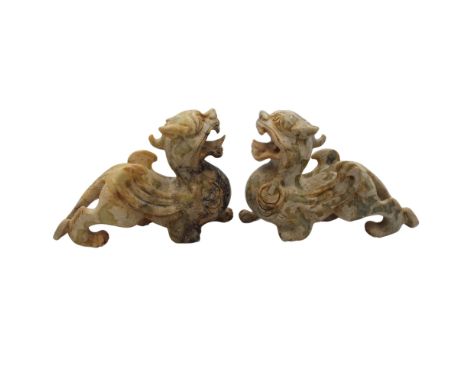 A pair of Chinese carved jade lion dogs, 20th century, height 14cm, length 19cm, width 8cm.
