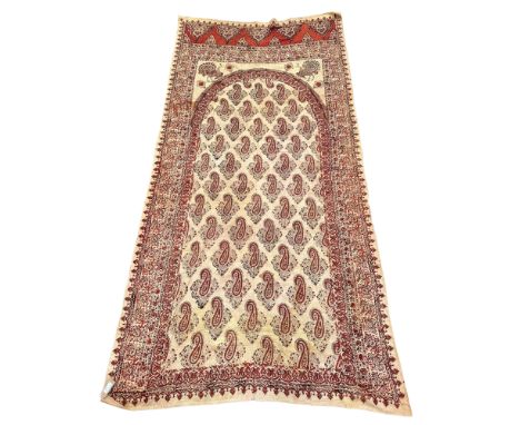 A paisley shawl, early 20th century, the ivory field with an arch filled with boteh, the spandrels decorated with two peacock