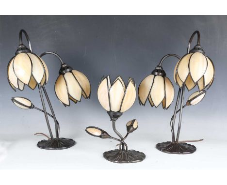 A set of three late 20th century Art Nouveau style bronzed metal three-light table lamps, all with stained glass flowerhead s