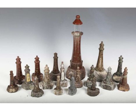 A collection of eighteen early 20th century Cornish turned serpentine model lighthouses, including some with thermometer atta