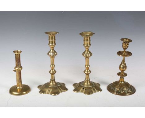 A pair of mid-18th century brass petal-based candlesticks, height 24cm, an 18th century brass hogscraper ejector candlestick 