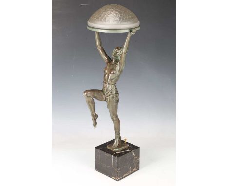 Max Le Verrier - an Art Deco green patinated cast spelter figural table lamp, finely modelled as a dancer holding a frosted g