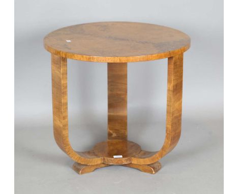 An Art Deco walnut circular occasional table, on four curved supports, height 59cm, diameter 63cm.